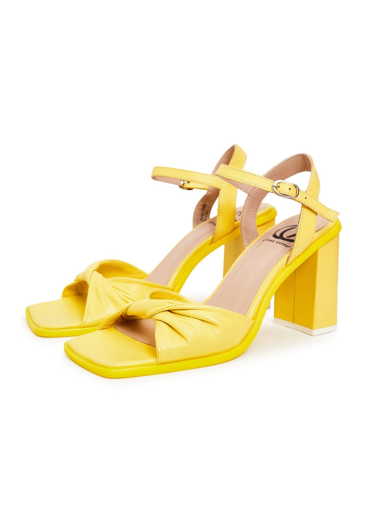 "Pair of fashionable yellow block heels, a timeless and stylish choice in women's footwear"