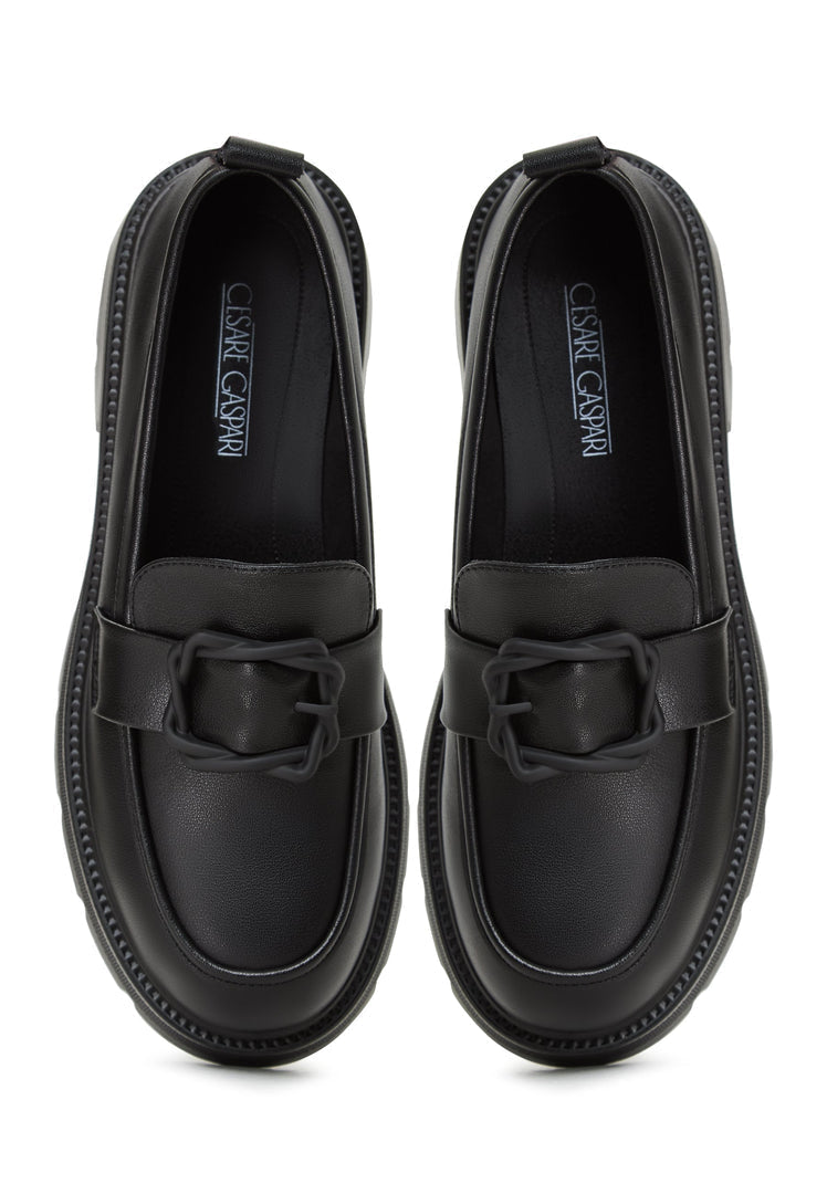 A stylish black platform loafers worn with a traditional Indian sari, making for fashionable women's footwear.