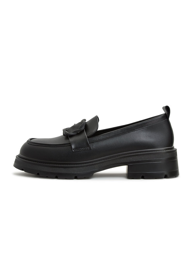 A stylish black platform loafers paired with a traditional sari, perfect women's footwear for a trendy and chic look.