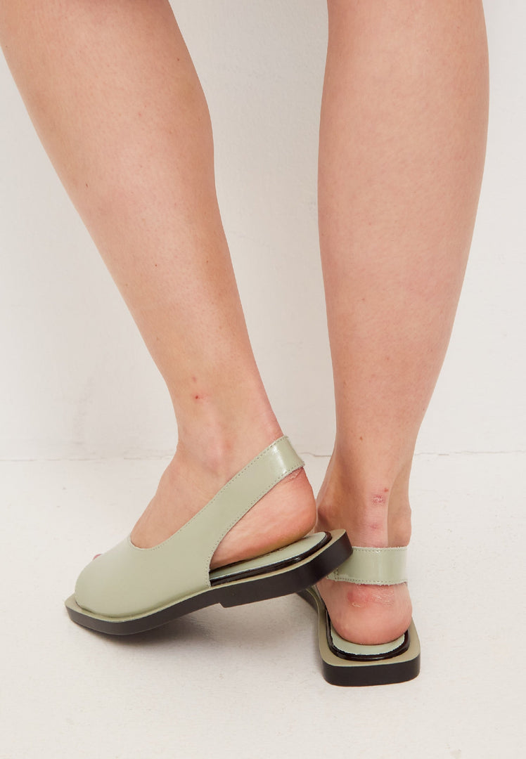 A stylish pair of open toe leather sandals, perfect for summer days in the city, offering a trendy and fashionable look in urban footwear.