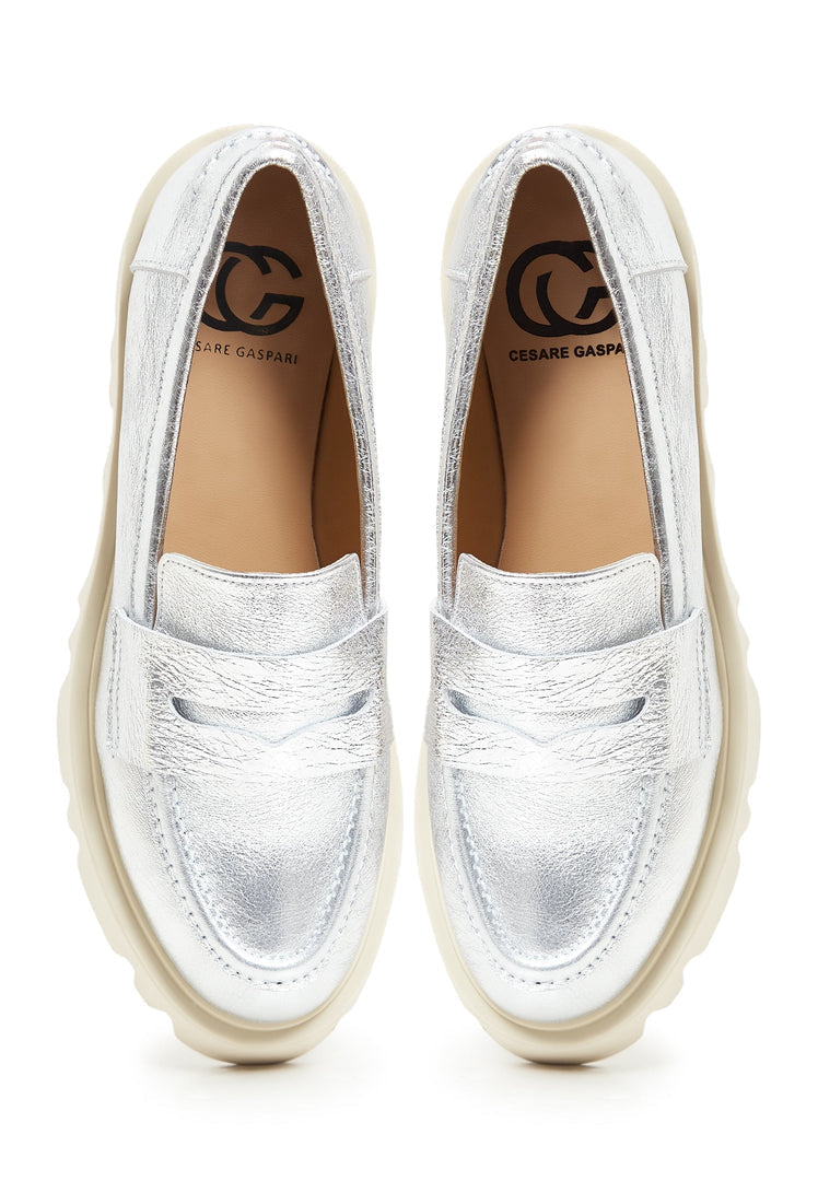 A stylish pair of chunky silver platform loafers for women, perfect for adding a fashion-forward touch to any outfit.