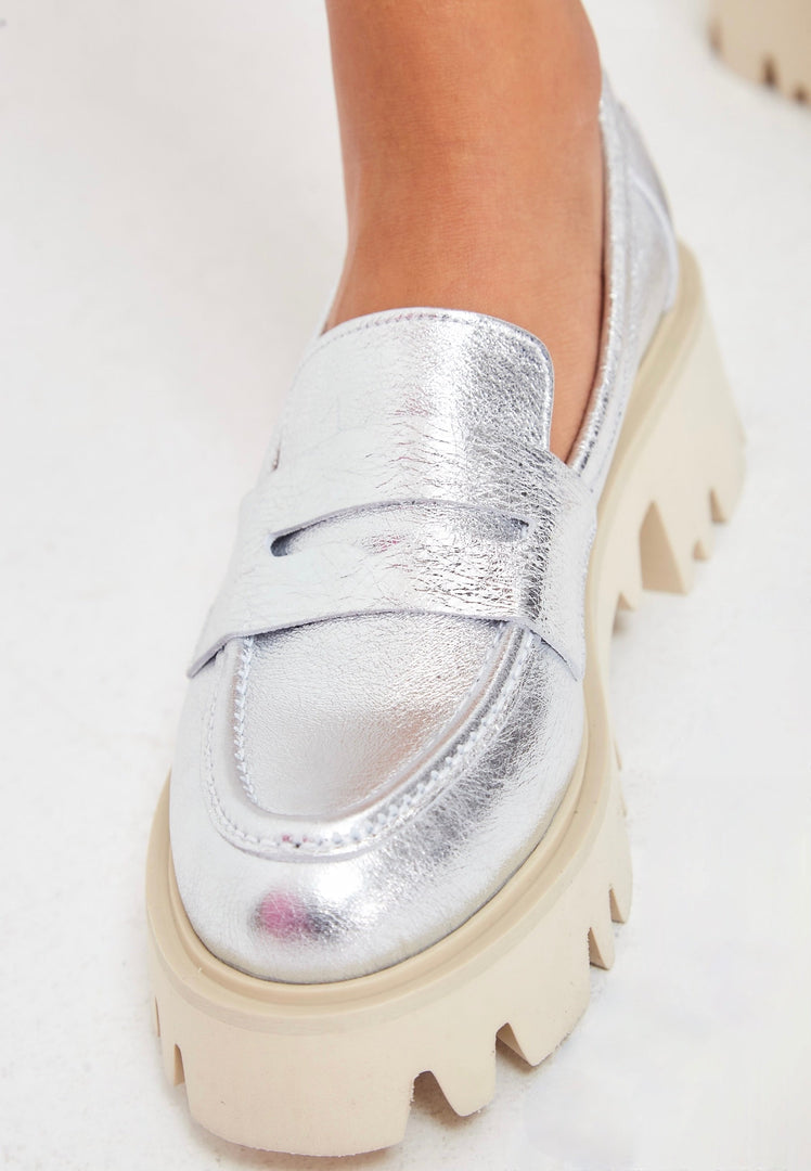 A trendy pair of chunky platform loafers in silver, perfect for fashionable women.