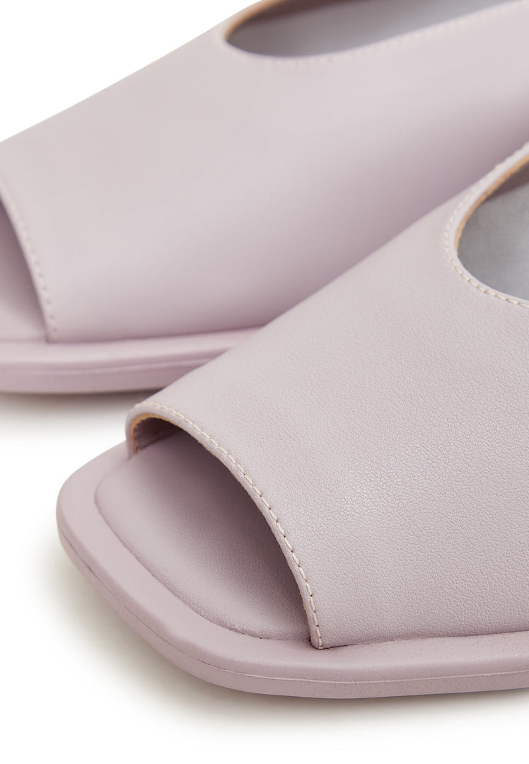 A pair of stylish women's flat sole violet sandals, perfect for summer and beach wear.