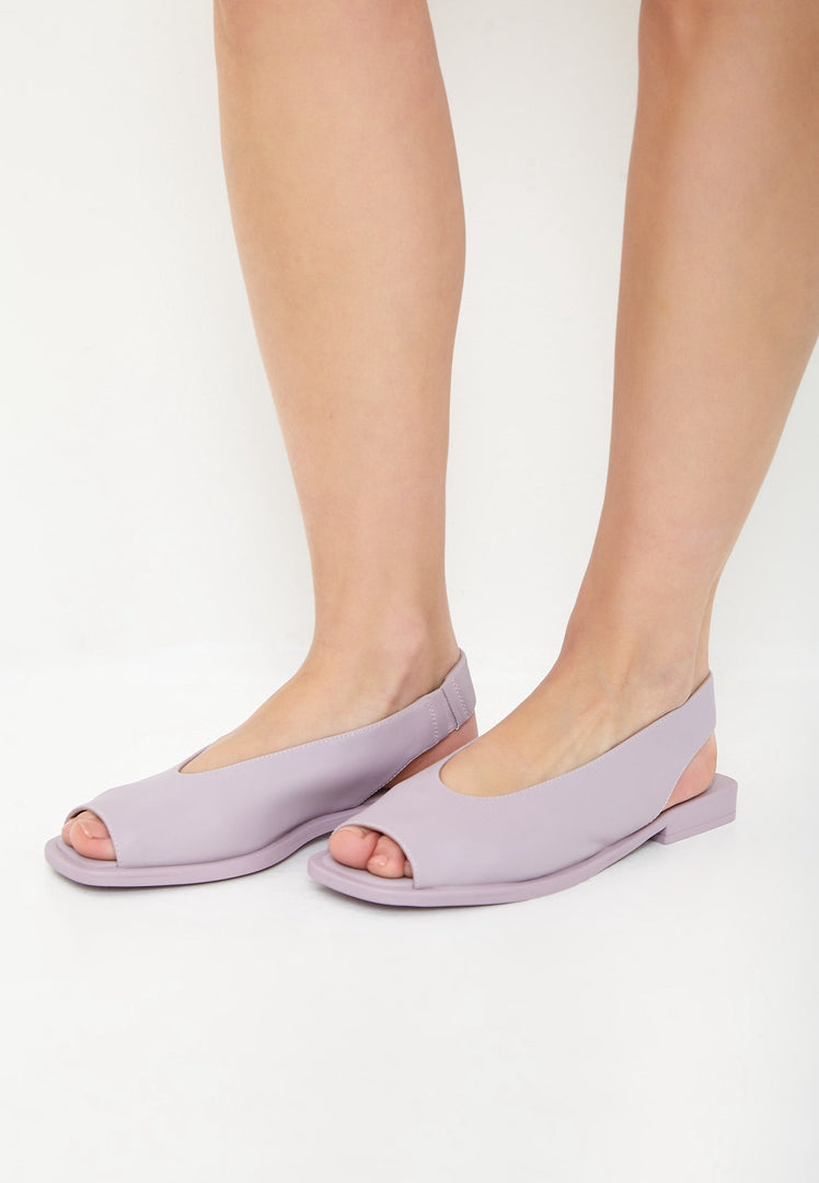 A pair of stylish violet flat sole women's sandals, perfect for summer and the beach.