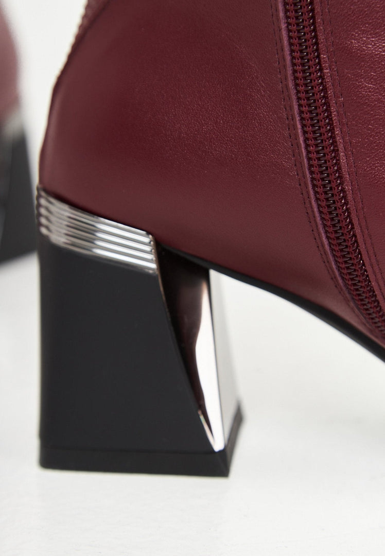 A chic pair of Bordeaux block heel ankle boots, a must-have for any woman's fall fashion wardrobe.