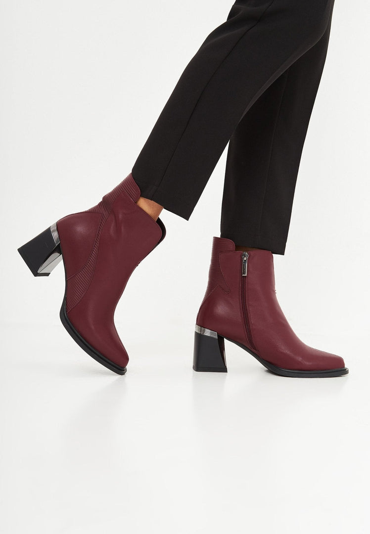 A stylish pair of bordeaux block heel ankle boots, perfect for fall fashion trends for women.