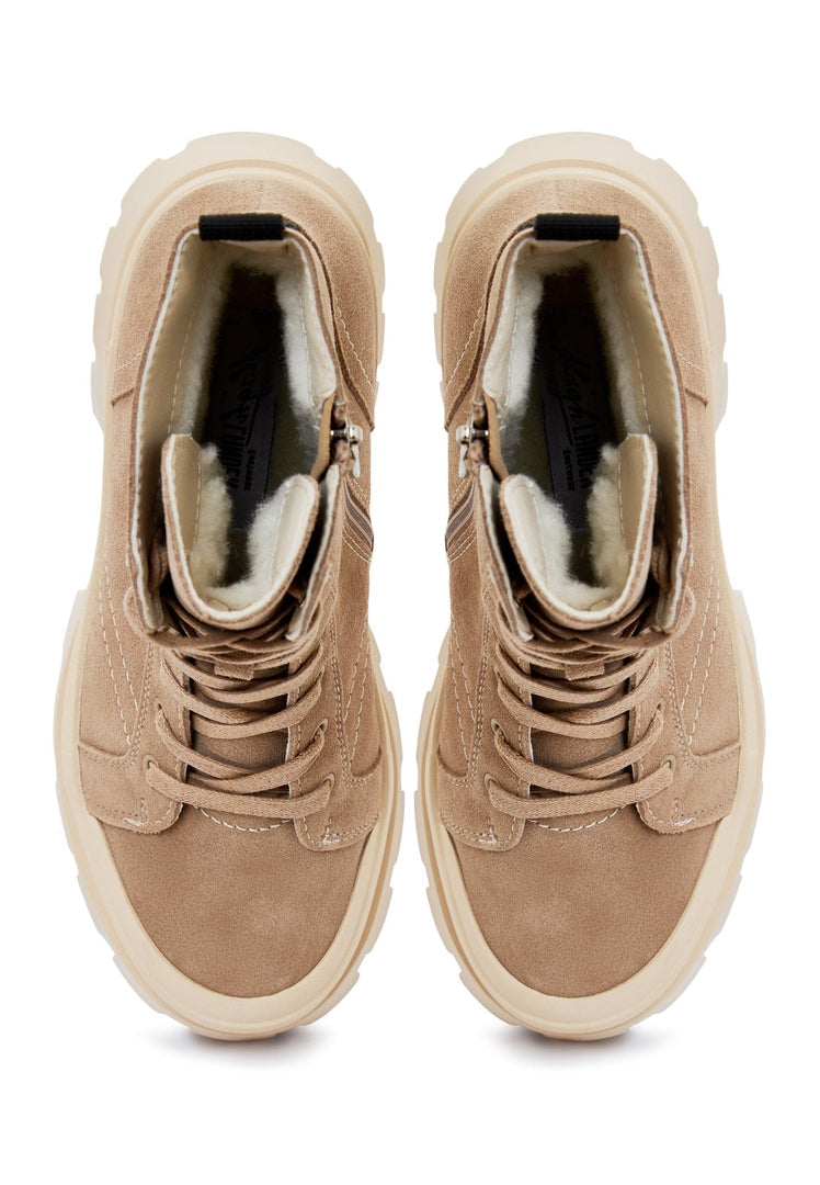 A stylish woman wearing trendy lace-up ankle boots, perfect for a fashionable street style look.