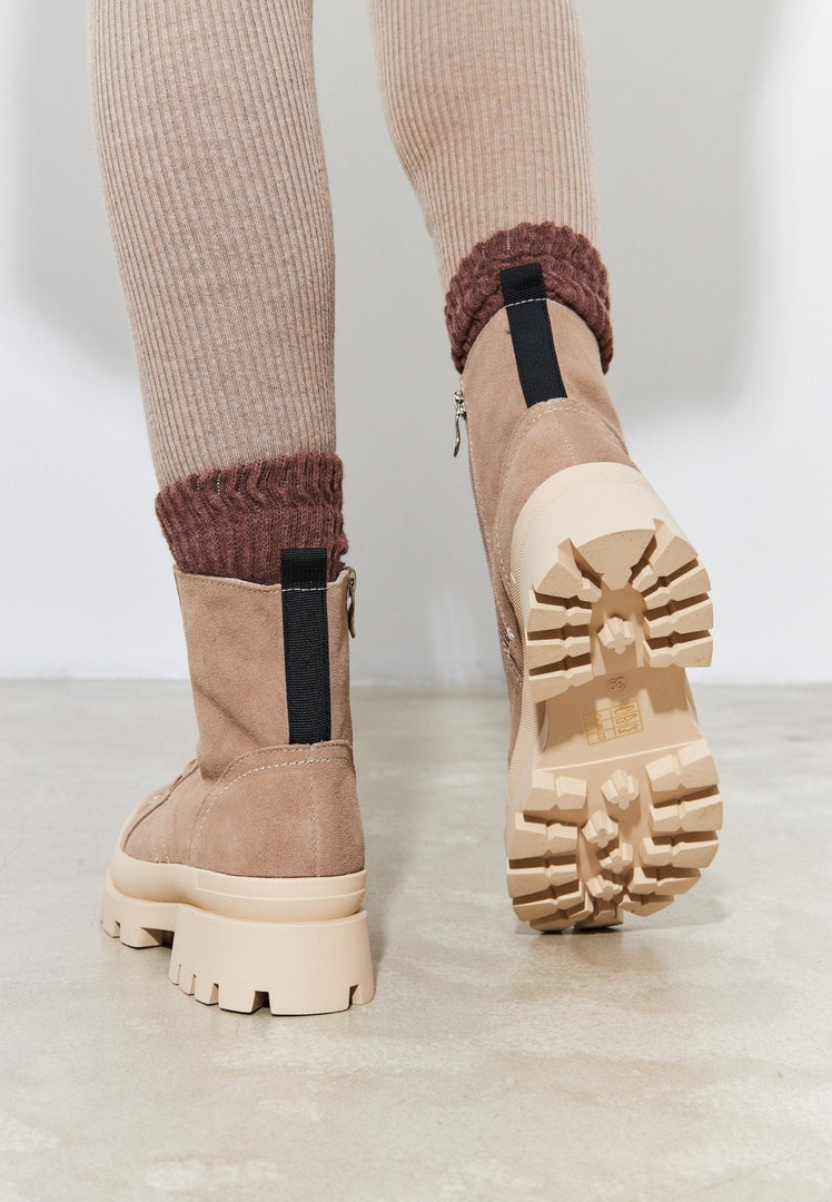A pair of stylish lace-up ankle boots that are trendy, chic, and perfect for fashionable street style urban footwear.