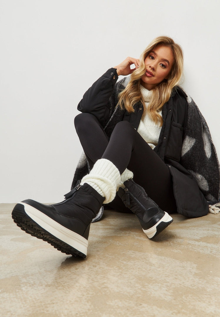 Stay warm and stylish this winter with these trendy black platform boots - the perfect choice for winter fashion.