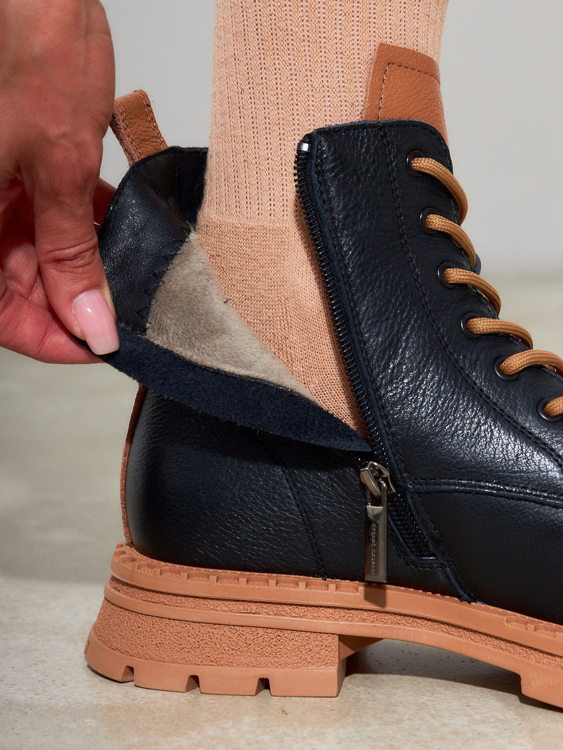 A stylish pair of lace-up black leather ankle boots for women - perfect for adding a fashionable touch to any outfit.