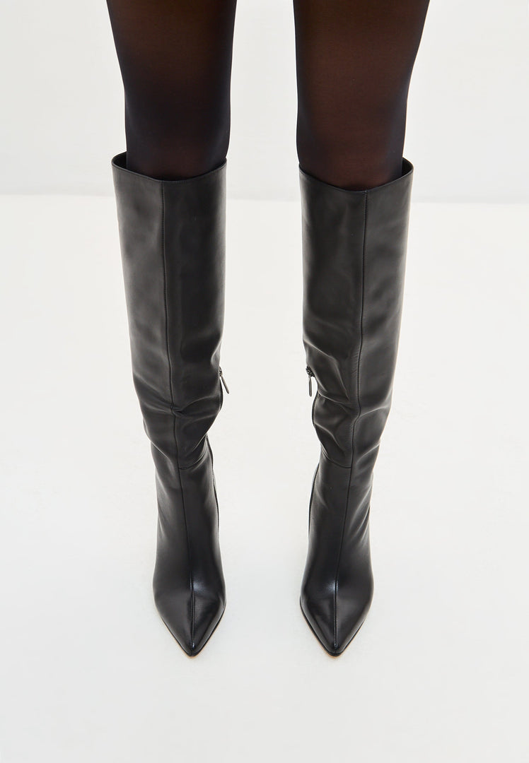 A stylish pair of black leather knee-high boots, the epitome of timeless footwear with high heel boots, showcasing sleek black boots embodying the latest knee-high boot trends.