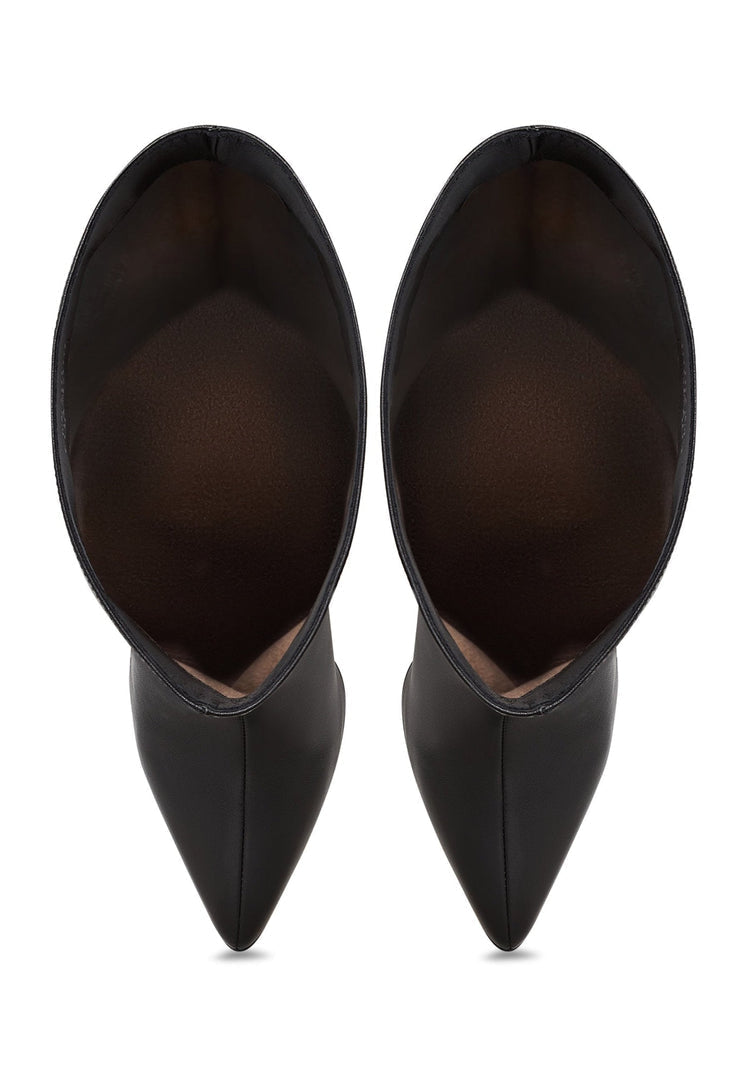 A pair of timeless black leather knee-high boots with high heels, showcasing sleek and trendy knee-high boot trends.