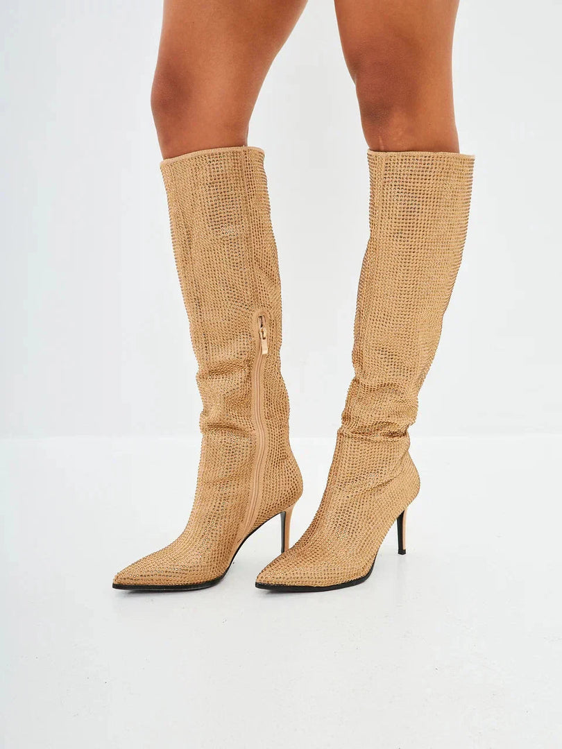 These luxurious Mili knee high boots feature stunning jewel embellishments and a glamorous gold stiletto heel.