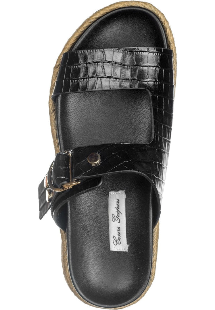 A pair of casual black slide sandals for women featuring a chic buckle strap design.