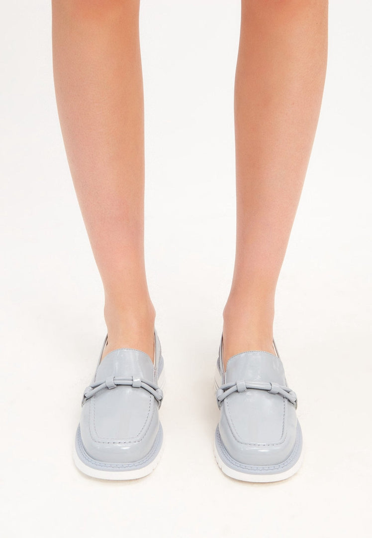 A stylish pair of blue block heels loafers for women, perfect for a fashionable and comfortable look.