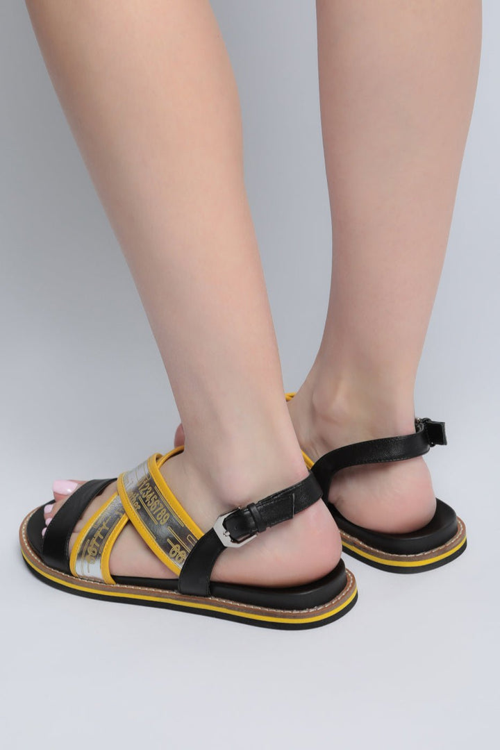 A pair of stylish urban leather sandals with a flat sole design, perfect for trendy city footwear.