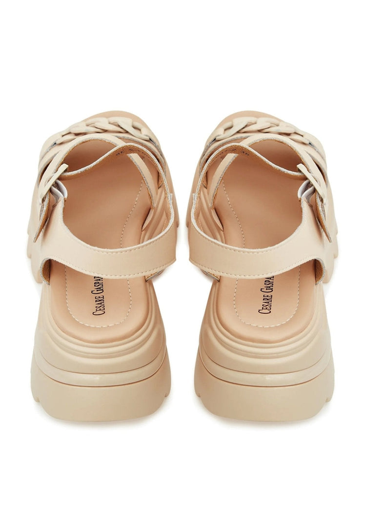 A pair of stylish women's leather platform sandals with high heels, perfect for a trendy and chic look.