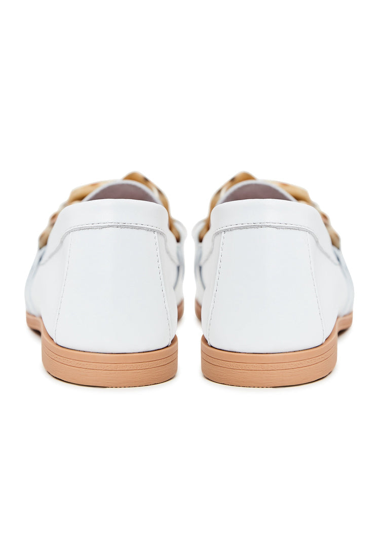 A close-up image of stylish white leather loafers with a flat sole, a classic choice for versatile footwear.