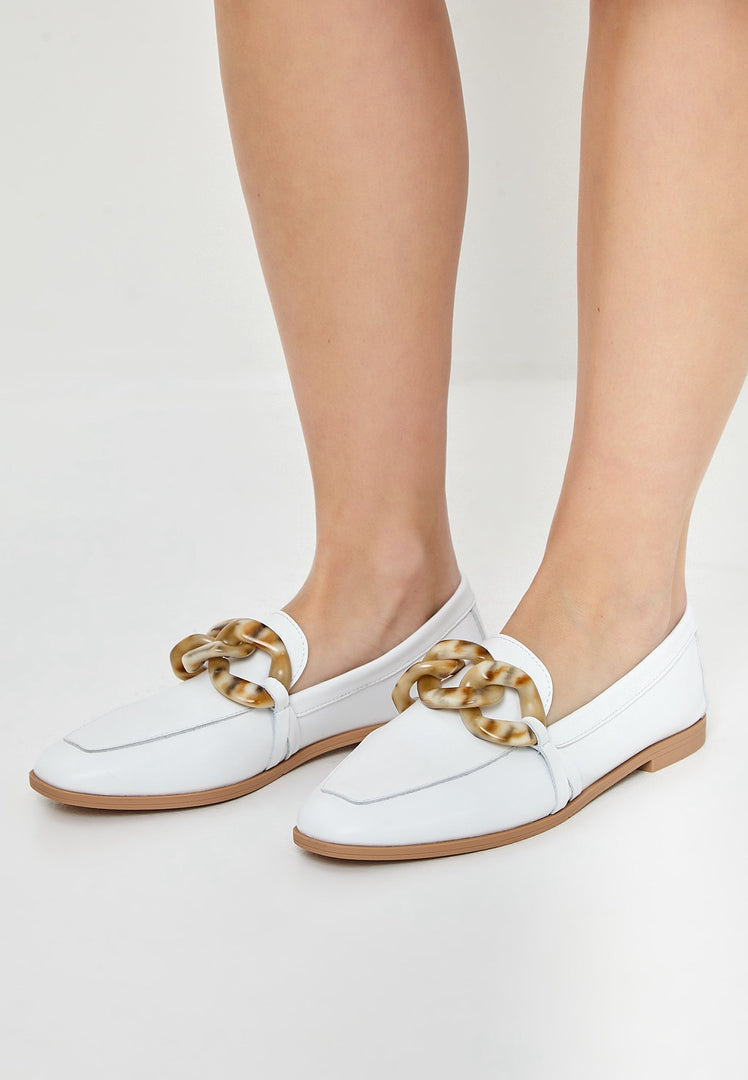 A pair of stylish white leather flat loafers, perfect for a classic footwear look with a flat sole.