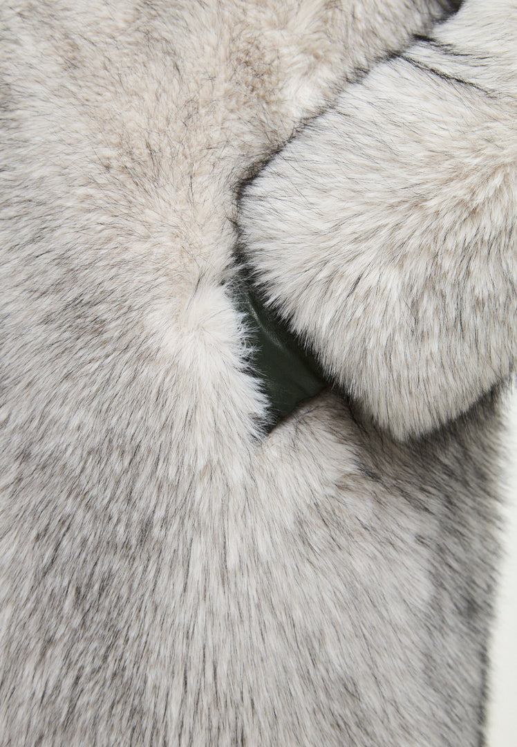 A stylish woman wearing a luxurious gray faux fur coat, the perfect winter fashion statement for women looking for a chic outerwear option.