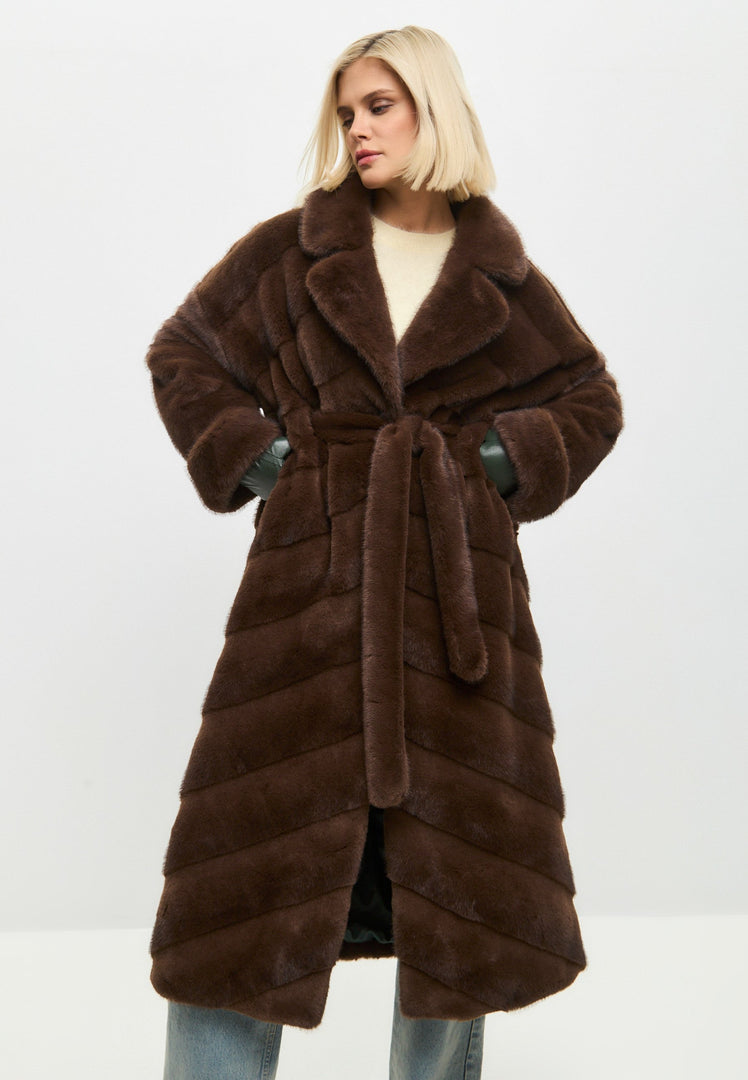 A trendy statement piece for winter fashion - an oversized brown faux fur coat for women's outerwear.