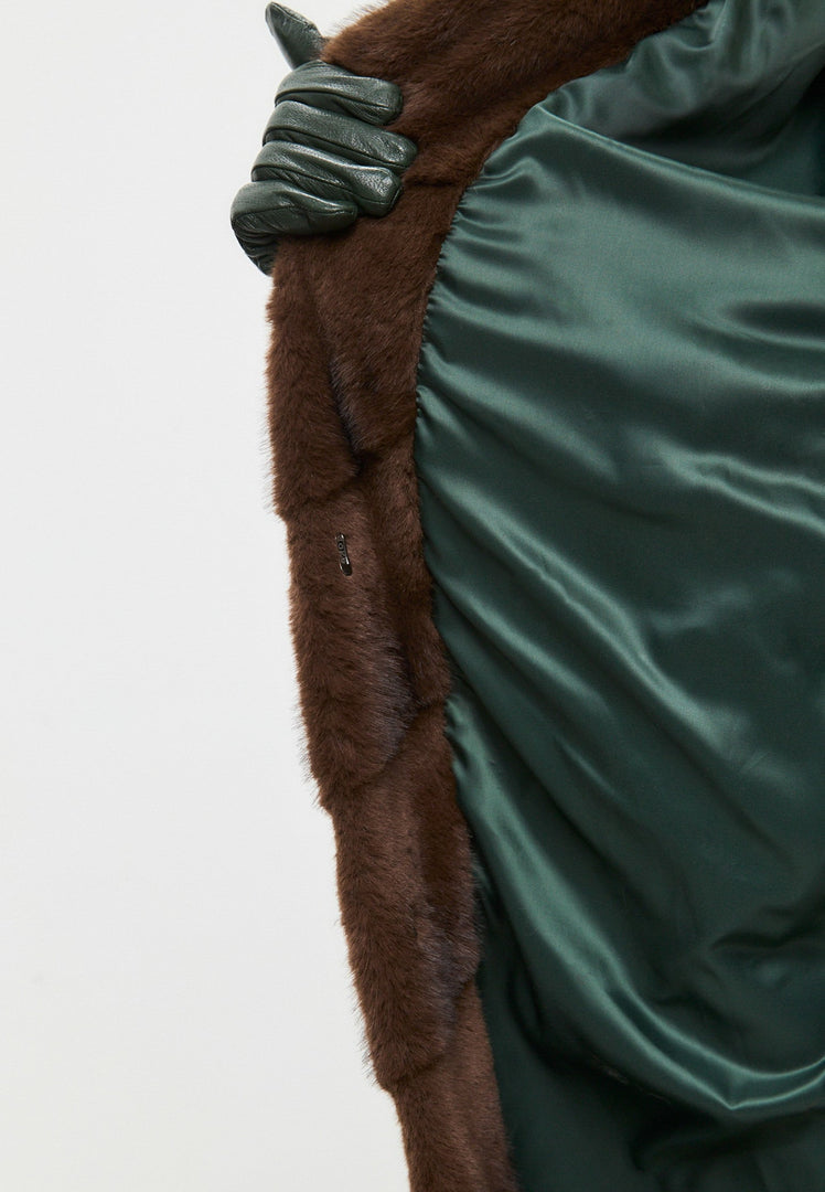 A stylish woman wearing an oversized brown faux fur coat, the perfect trendy statement piece for winter fashion in women's outerwear.