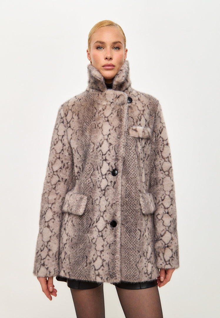 A trendy Niuvis beige faux fur coat with snake print, the epitome of stylish outerwear for trendy winter fashion.