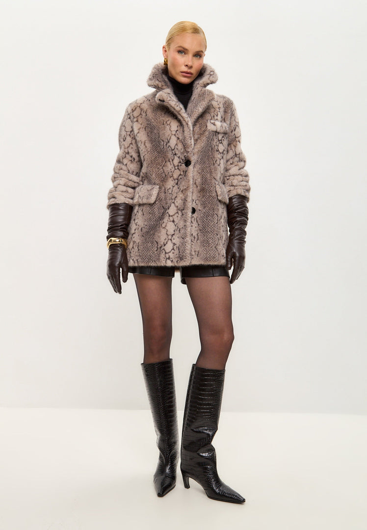 A stylish Niuvis snake print coat in beige faux fur, the perfect trendy winter fashion outerwear.
