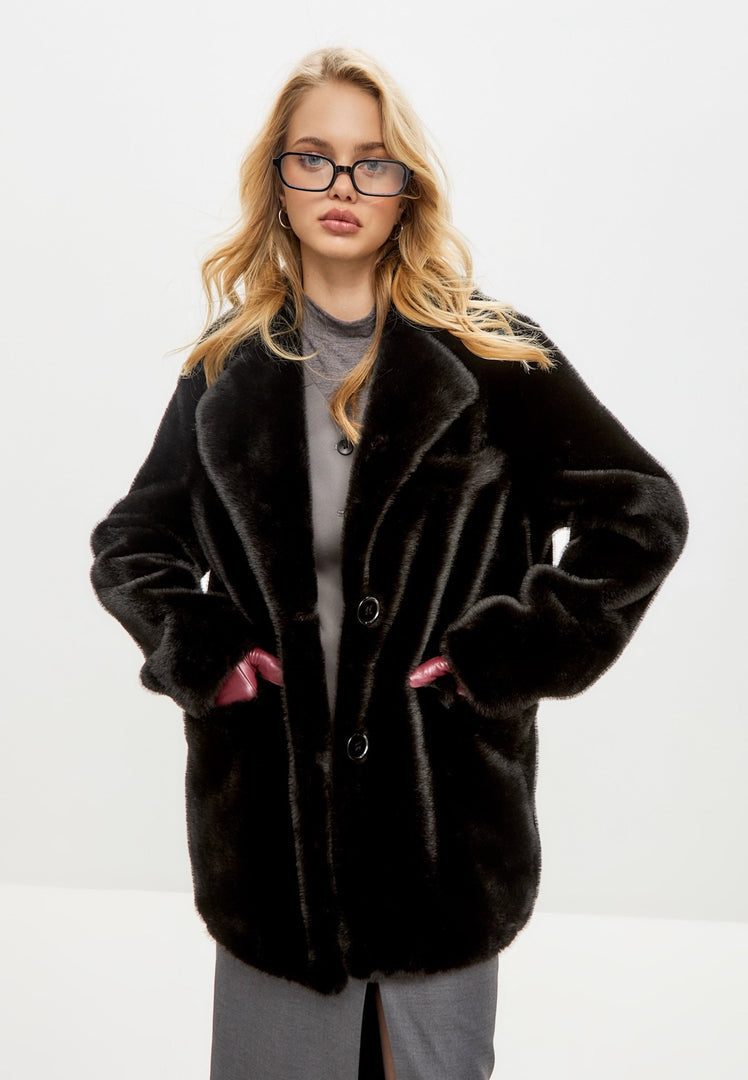 A stylish black faux fur Niuvis coat, the epitome of a chic and on-trend fashion coat.