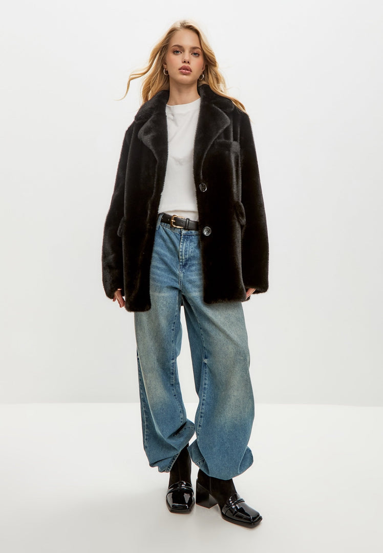 A stylish and trendy black faux fur Niuvis coat, perfect for adding a touch of chic fashion to any outfit.