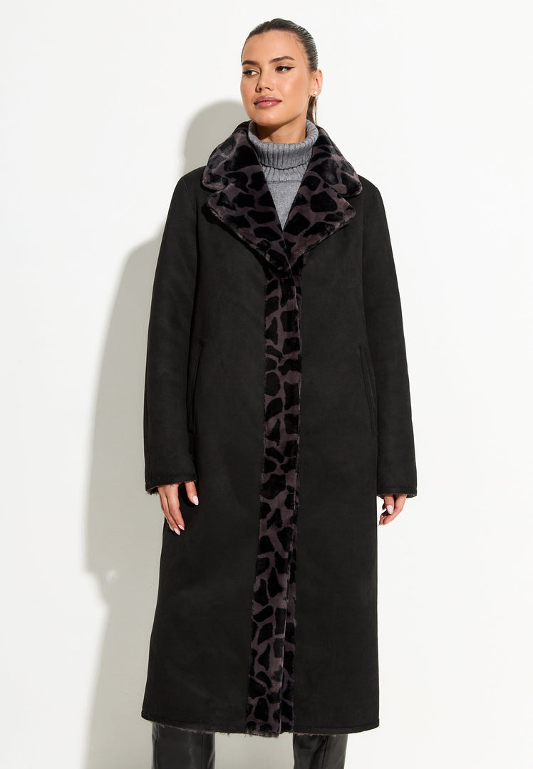 A stylish and cozy reversible Pantera faux fur coat in black, the perfect animal print outerwear for a fashionable winter look.