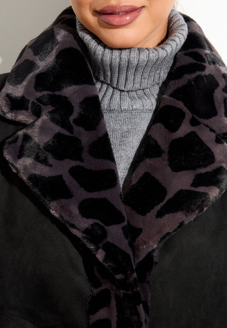 A stylish reversible animal print faux fur coat in black, featuring a chic Pantera design, perfect for trendy winter fashion looks.
