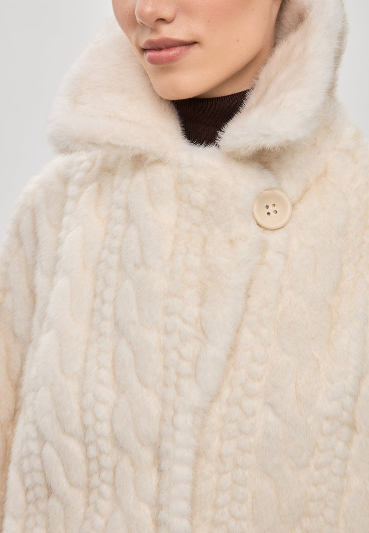 A stylish cream cable knit coat with faux fur trim, perfect for a cozy and elegant winter look.