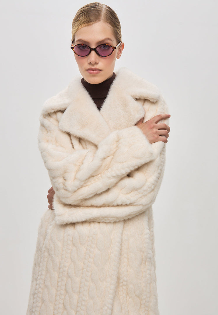 An elegant cream cable knit coat with faux fur trim, perfect for staying cozy and chic in the winter - introducing the stylish knit fur jacket, Faux Fur Coat Hildi.
