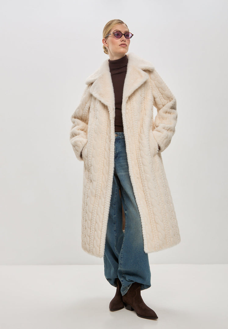 Stay warm and stylish this winter with an elegant cream cable knit coat featuring faux fur details like the Hildi faux fur coat.