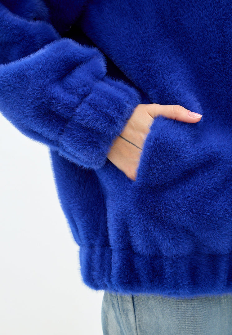 A stylish short blue faux fur coat inspired by Marilyn Monroe's iconic style, perfect for outerwear fashion.