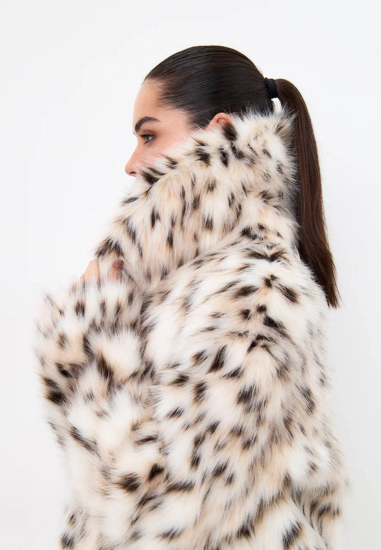 Stay stylish and warm this winter with a luxurious faux fur spotted coat - the ultimate statement piece for your winter fashion wardrobe.