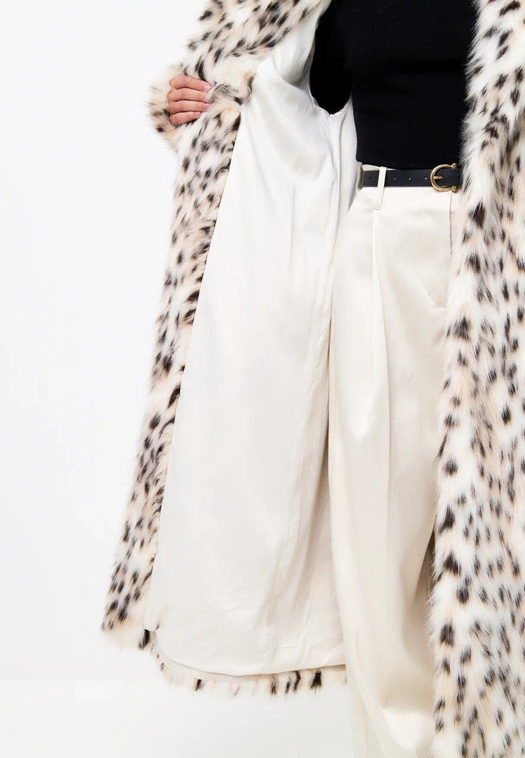 A stylish faux fur spotted luxe long coat, perfect for winter fashion.