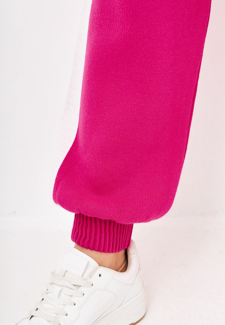 A stylish women's pink knitted jogger set, perfect for a casual knitwear outfit.